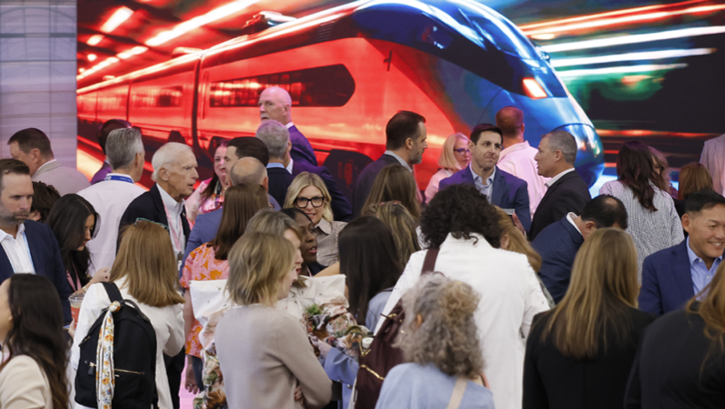 buyers, attendees and exhibitors gather by brightly colored activations on the show floor