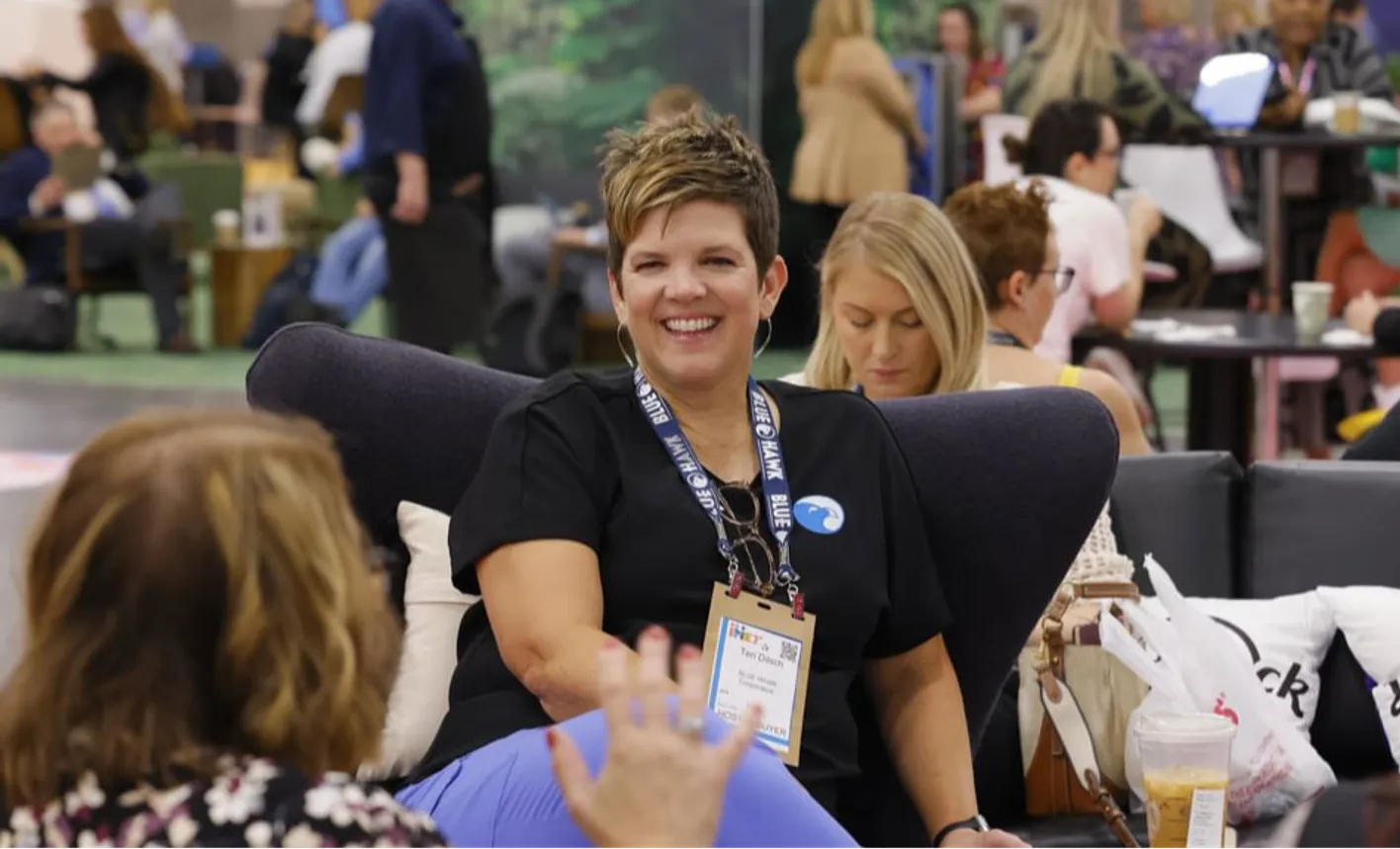 Hosted buyer smiling at camera in the IMEX Hosted Buyer Lounge