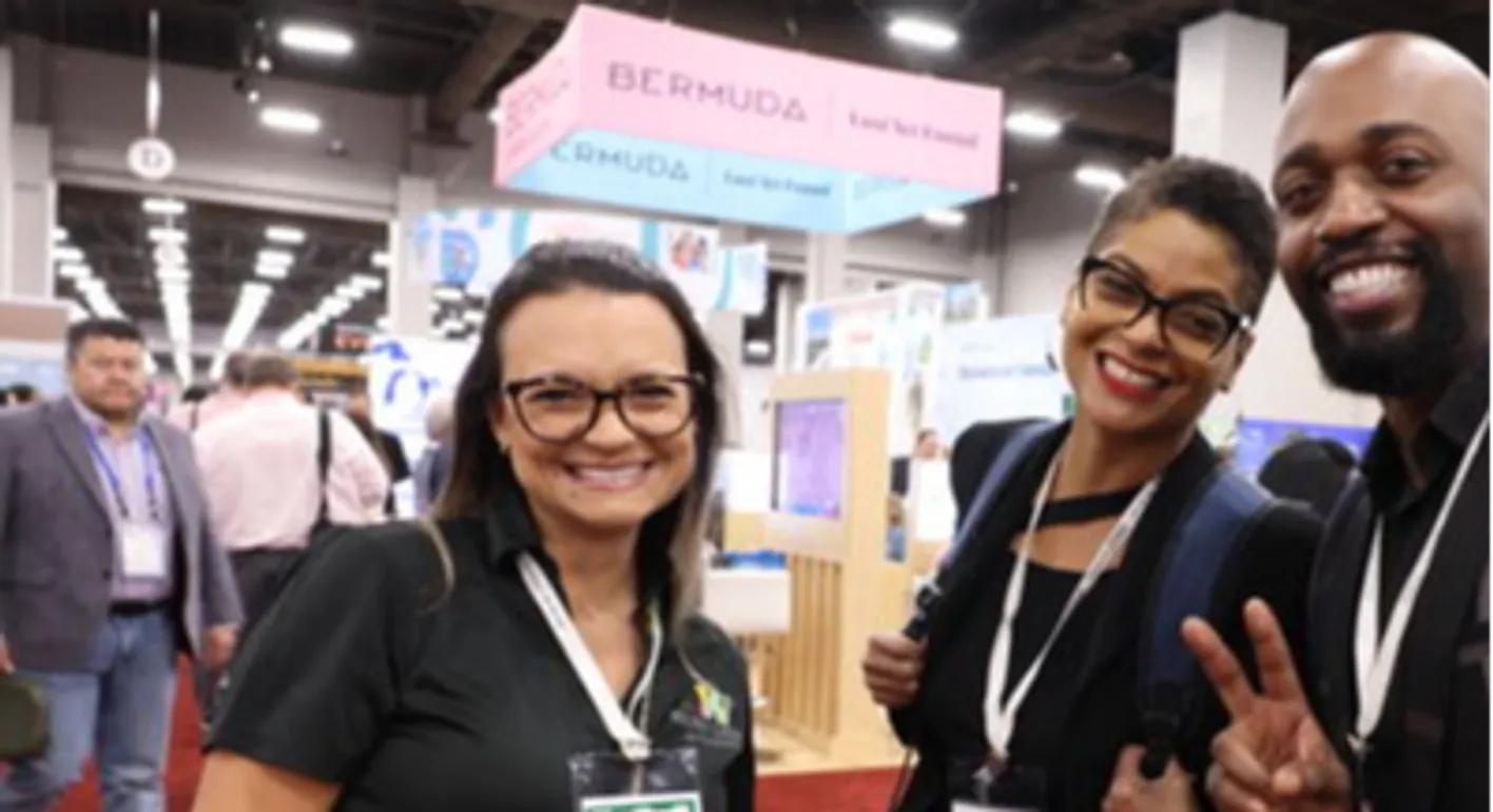 Group of event professionals beaming at the camera amid the energy of the show floor