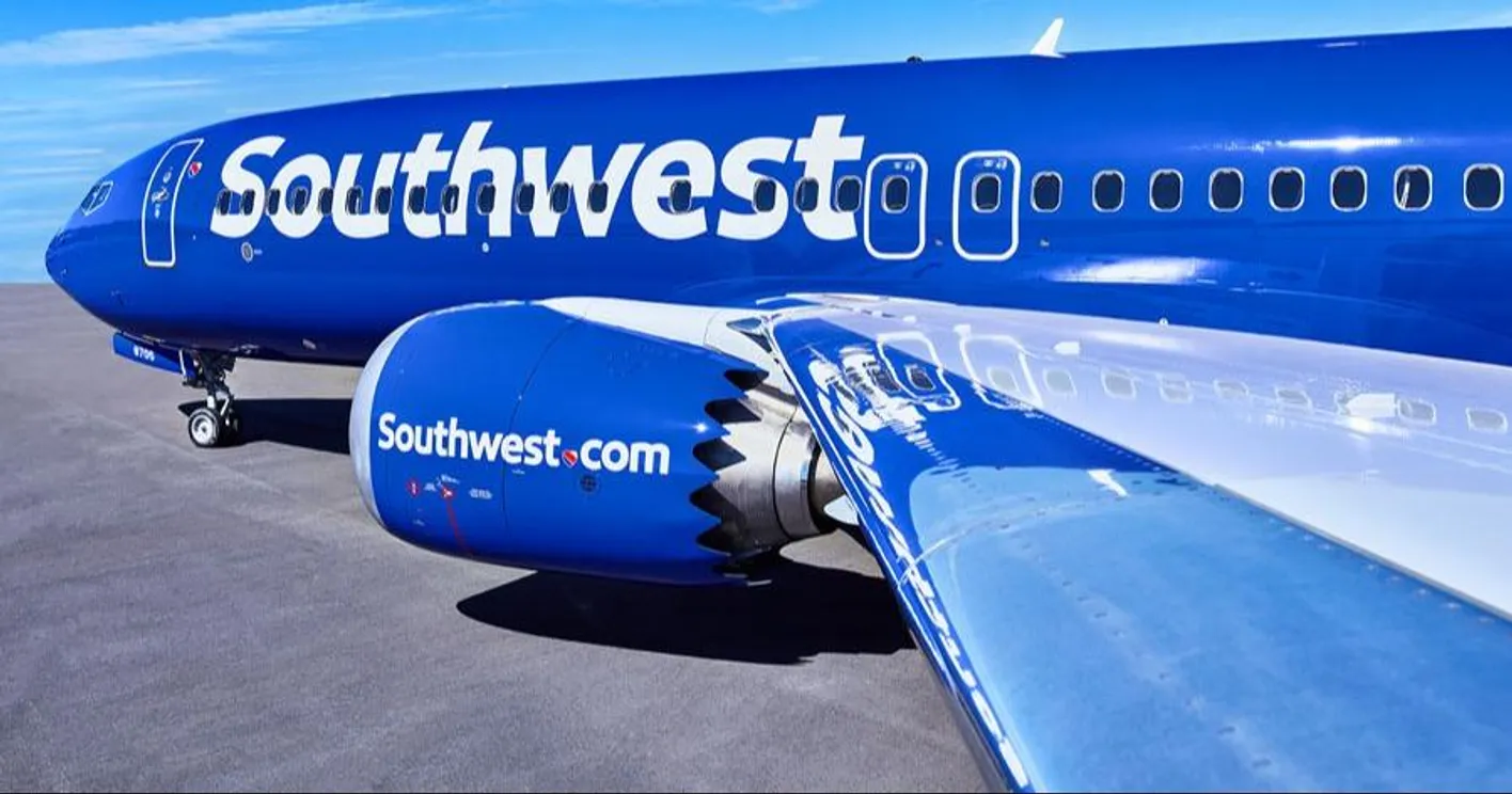 Branded Southwest business plane on tarmac against a blue sky
