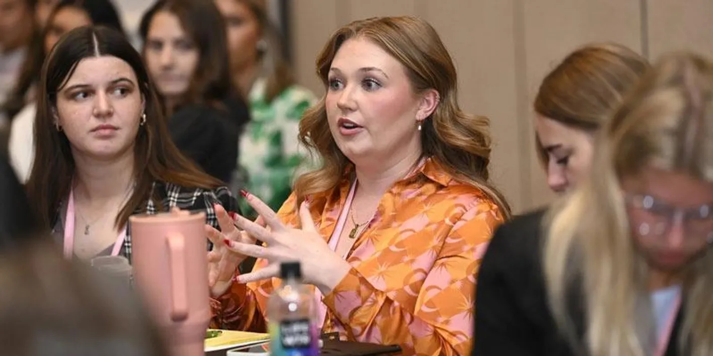 Audience participation with close up of female during future leads forum at IMEX America