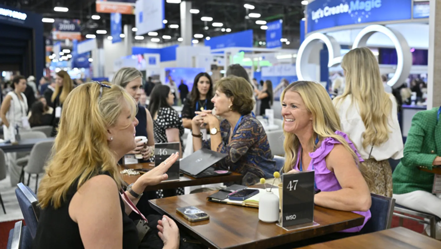 Meetings professionals engaged in conversation at a booth