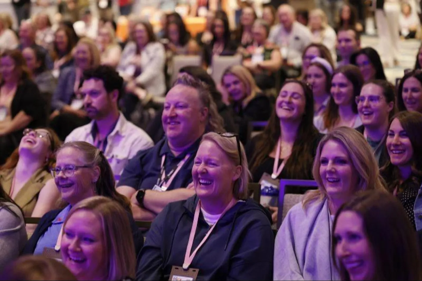 Engaged attendees glancing at the stage during a live learning session at Smart Monday