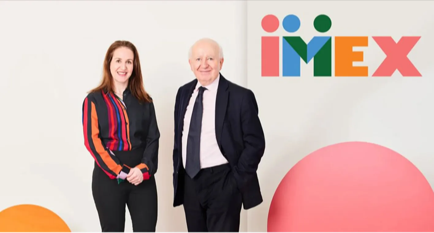 Carina Bauer and Ray Bloom in front of imex branding 