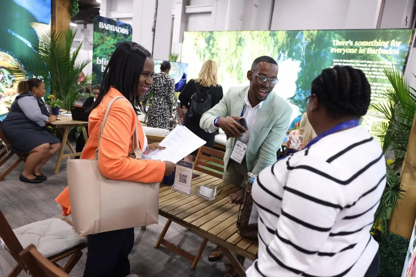 Staff at an exhibitor booth conversing while standing