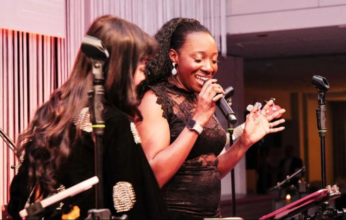 Female singers from Song Division singing into a microphone