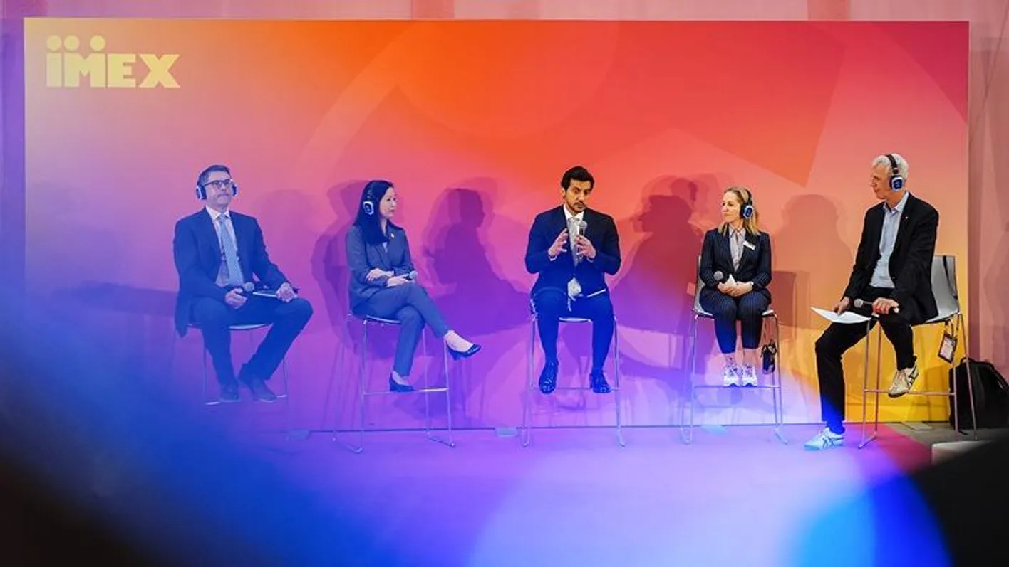 Speakers onstage with a colourful backdrop during an IMEX Frankfurt education session in Hall 9