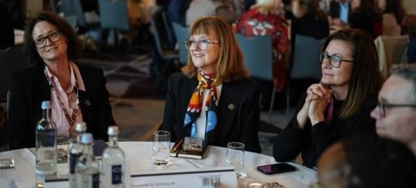 A close up of a table with colleagues at the place leaders forum