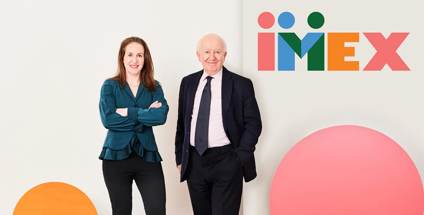 CEO, Carina Bauer, and Chairman, Ray Bloom, smiling in front of the IMEX logo on a white background.