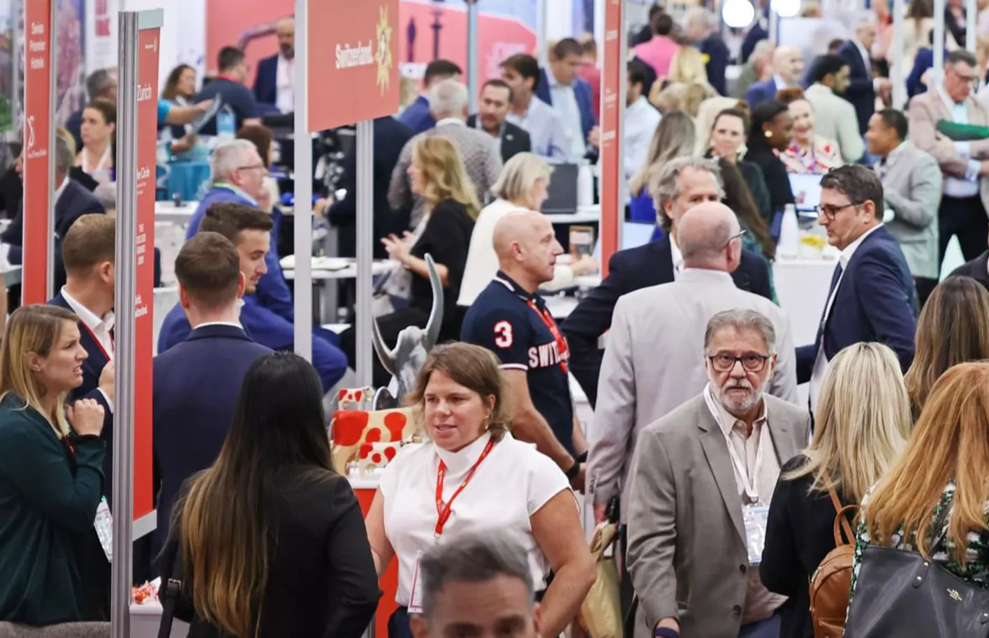 Many people gathered on the show floor speaking with exhibitors