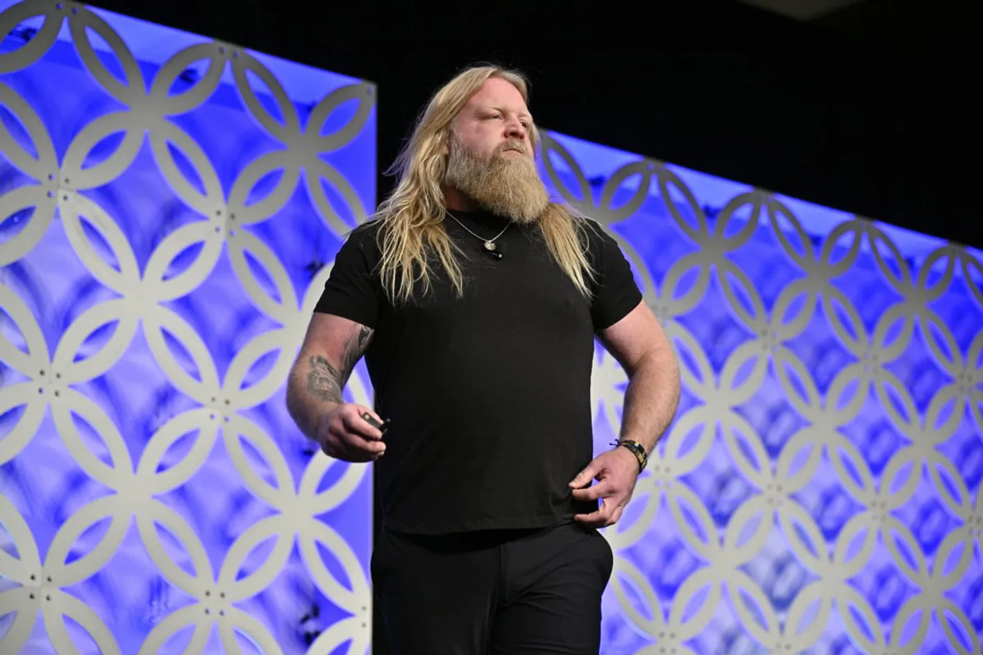 Keynote speaker and wrestler onstage delivering inspiring talk