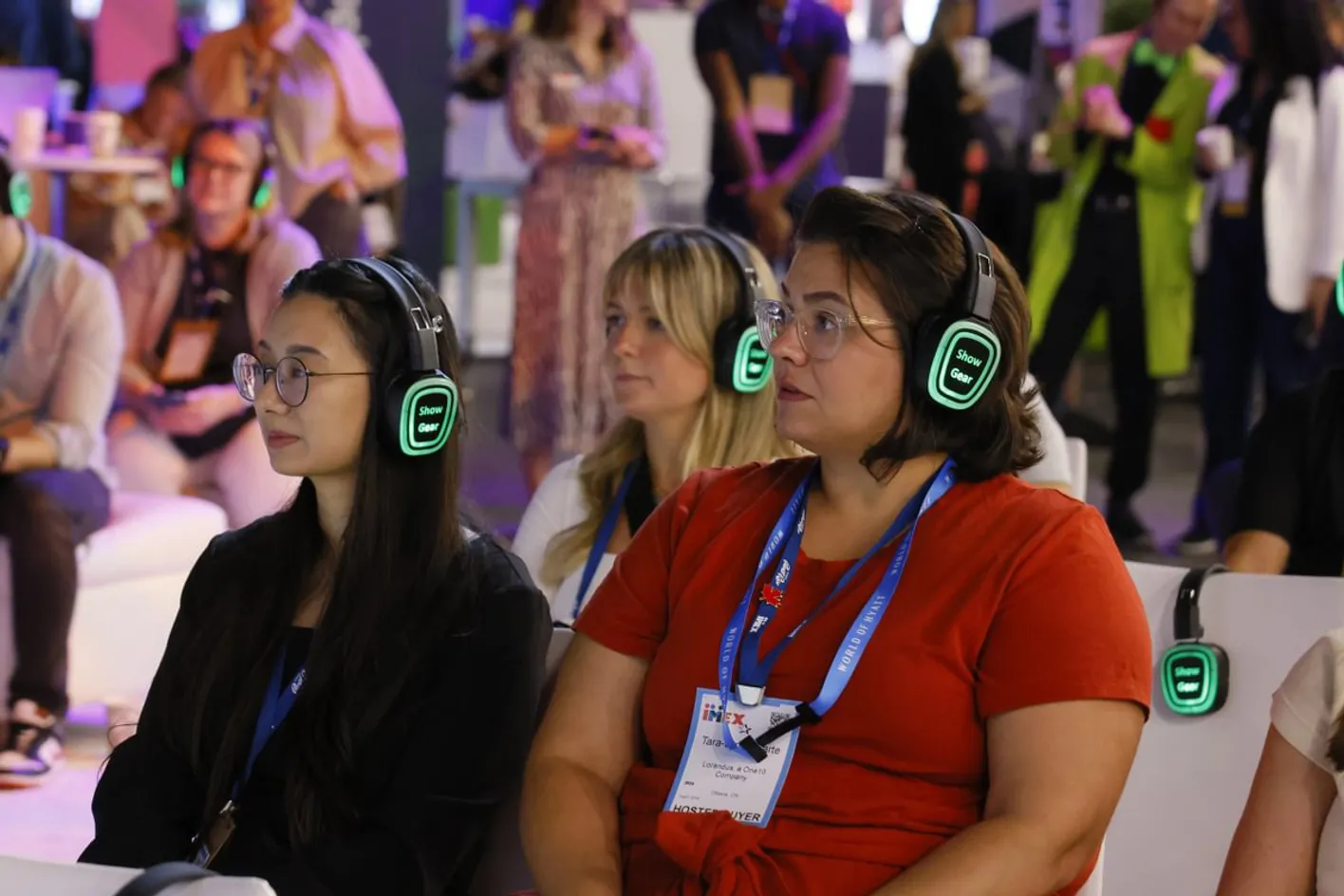A crowd listening to education session with audio headphones.