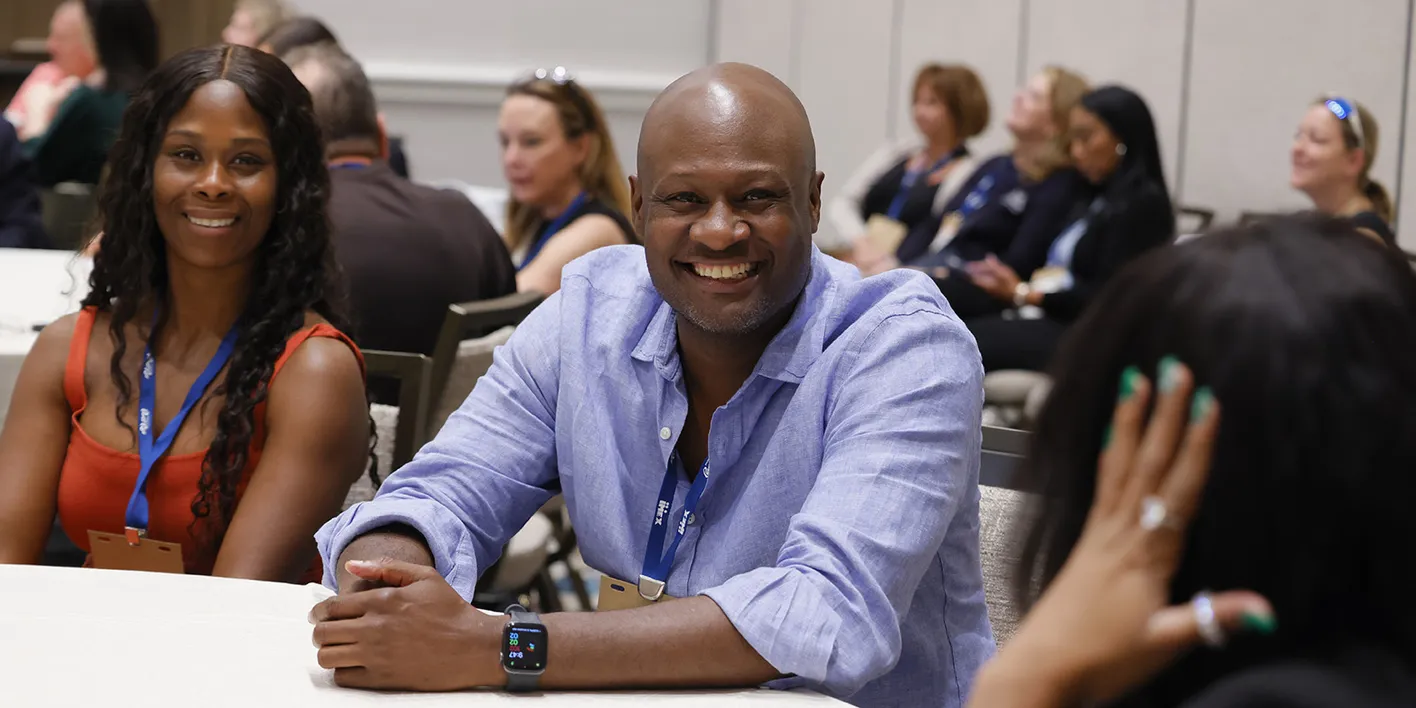 Agency participants smiling while attending a panel