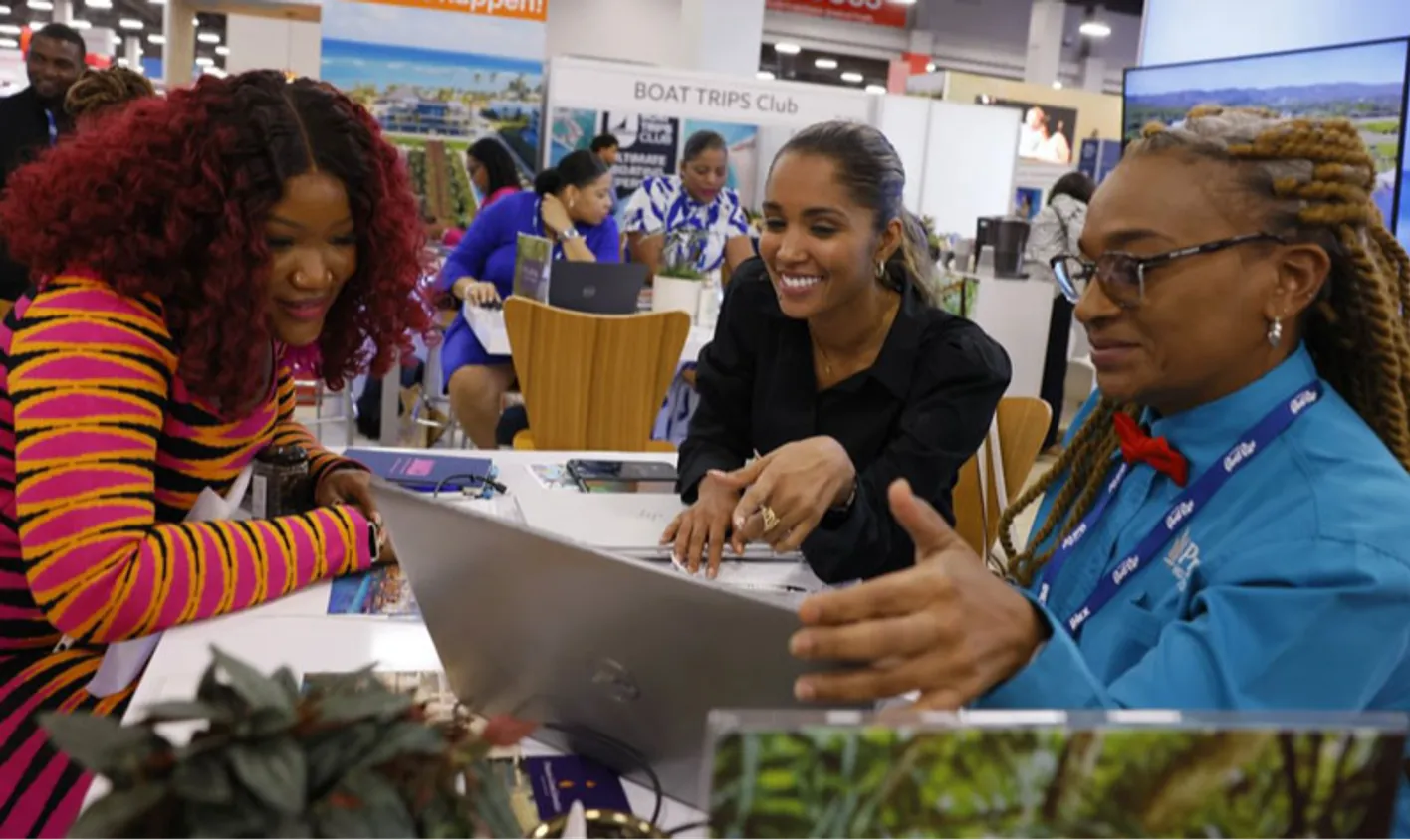 Busy tradeshow floor with attendees networking and holding face-to-face meetings