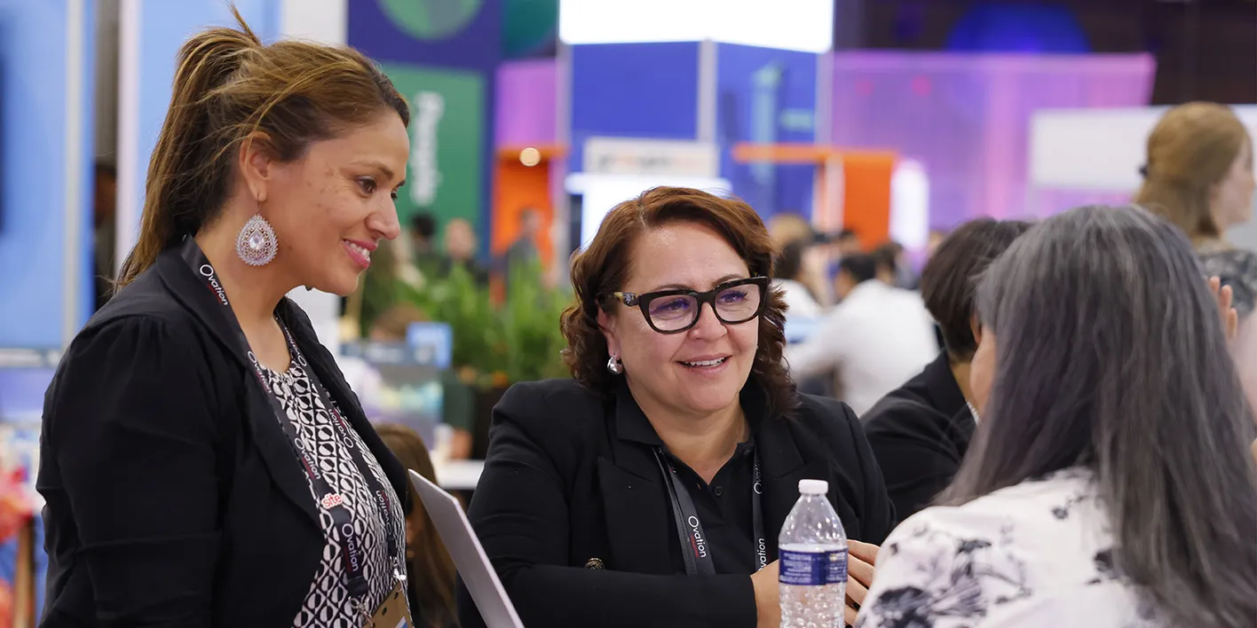 Engaged hosted buyers at exhibitor booth