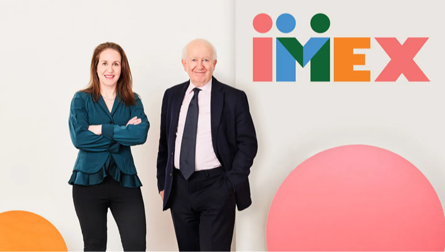 Ray Bloom and Carina Bauer in front of IMEX signage