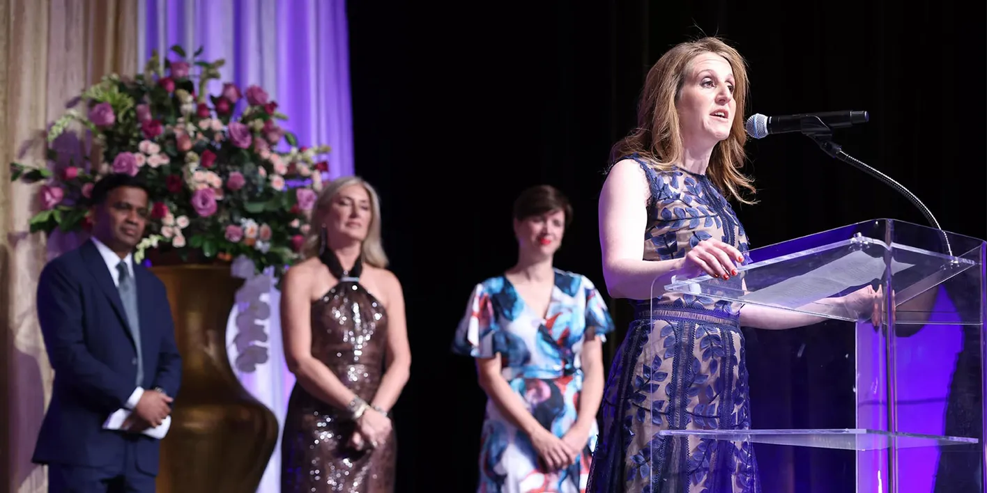 Carina Bauer on stage and speaking into microphone during the EIC global awards celebration