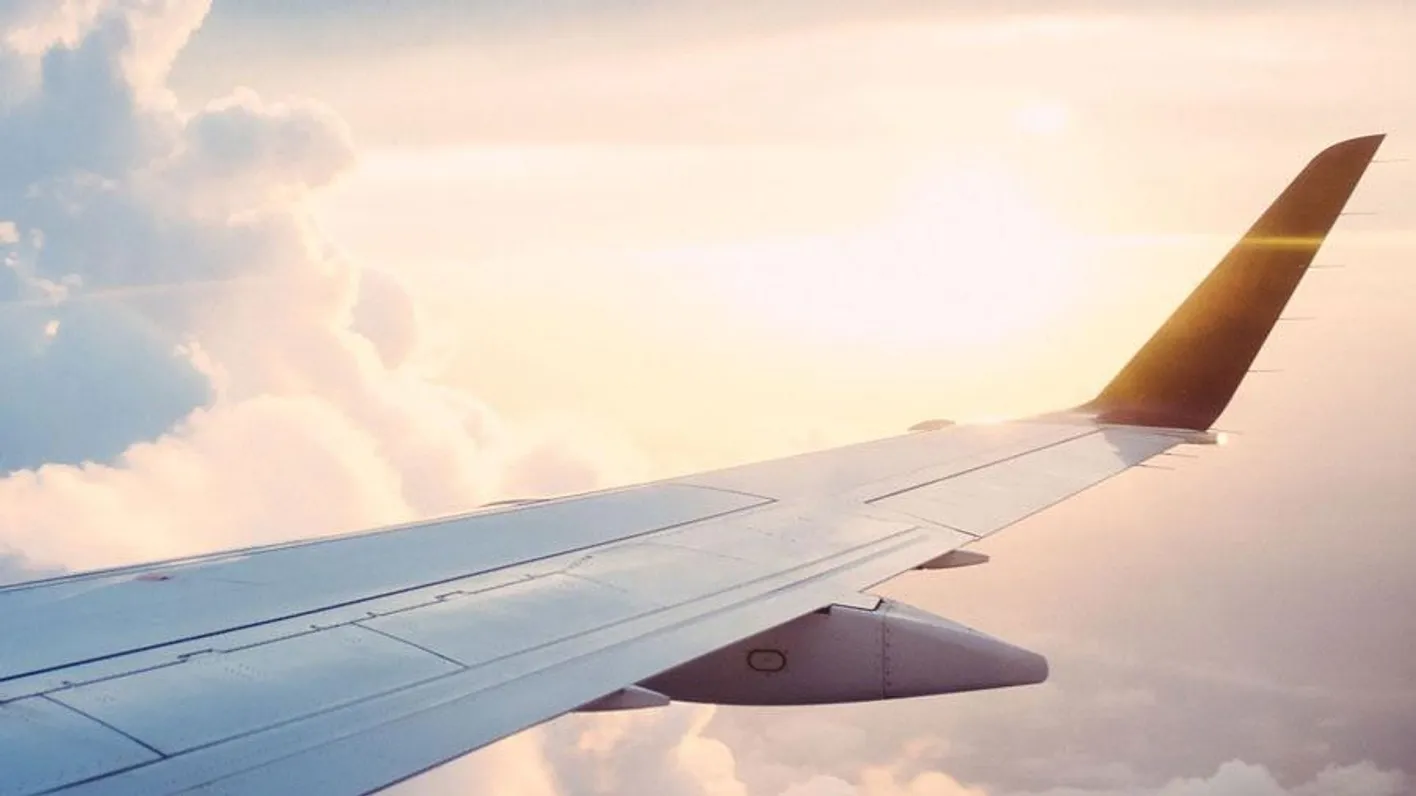 Plane in the sky with the sunsetting