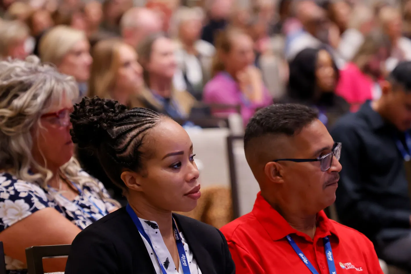 Audience members gazing towards the stage during an education session
