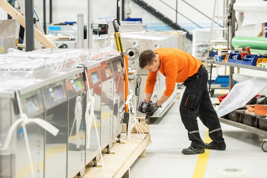 A FinnSonic employee packs products for export.