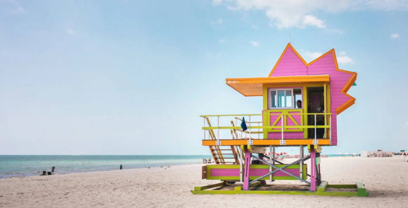 A pink lifeguard tower on a beach in Miami.