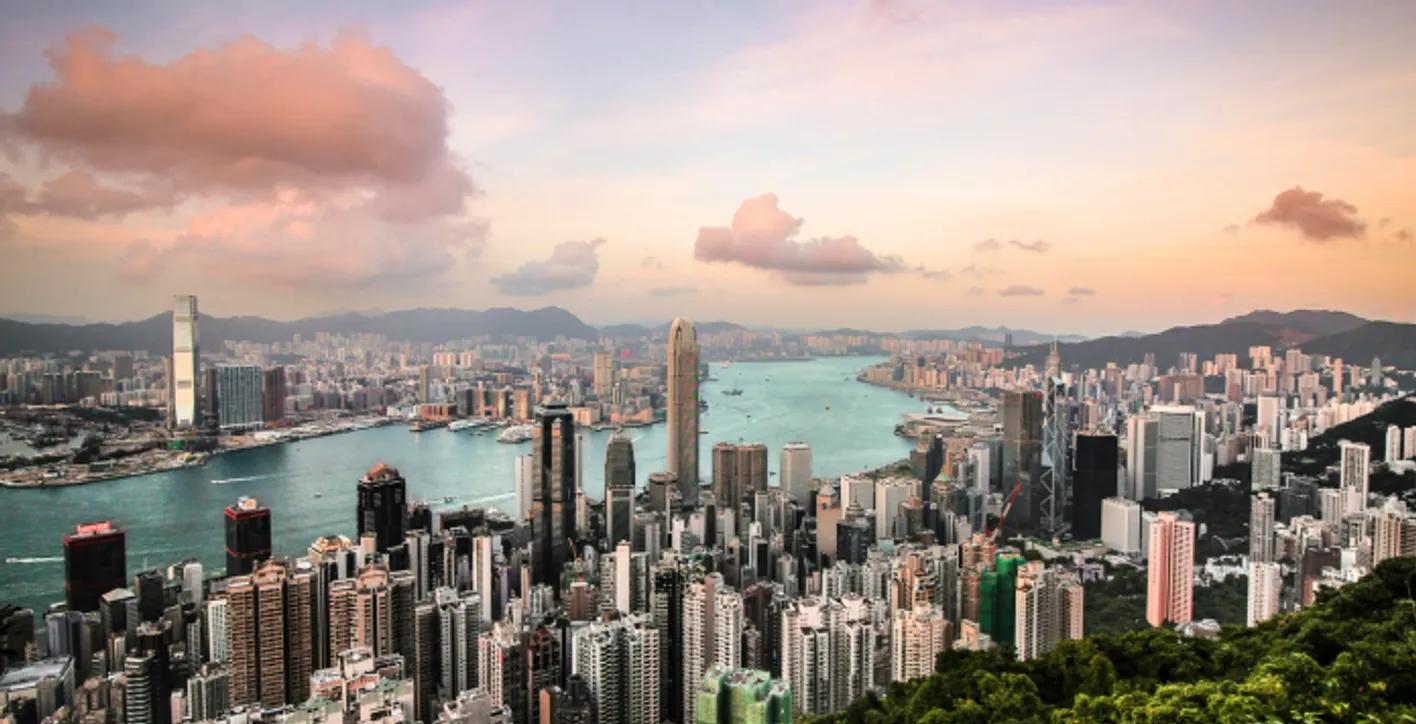 Aerial view of Hong Kong’s Victoria Harbour and city skyline at sunset