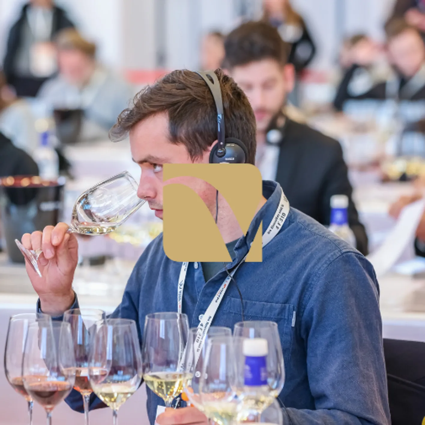 Wine professional tasting wine during a masterclass session with audio headset