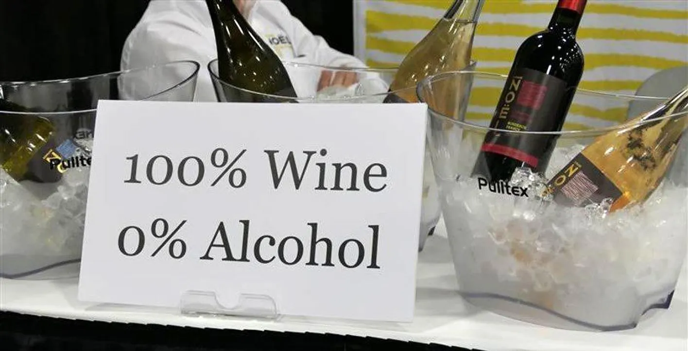Buckets of wine and a paper sheet where it is written 100% Wine 0% Alcohol.