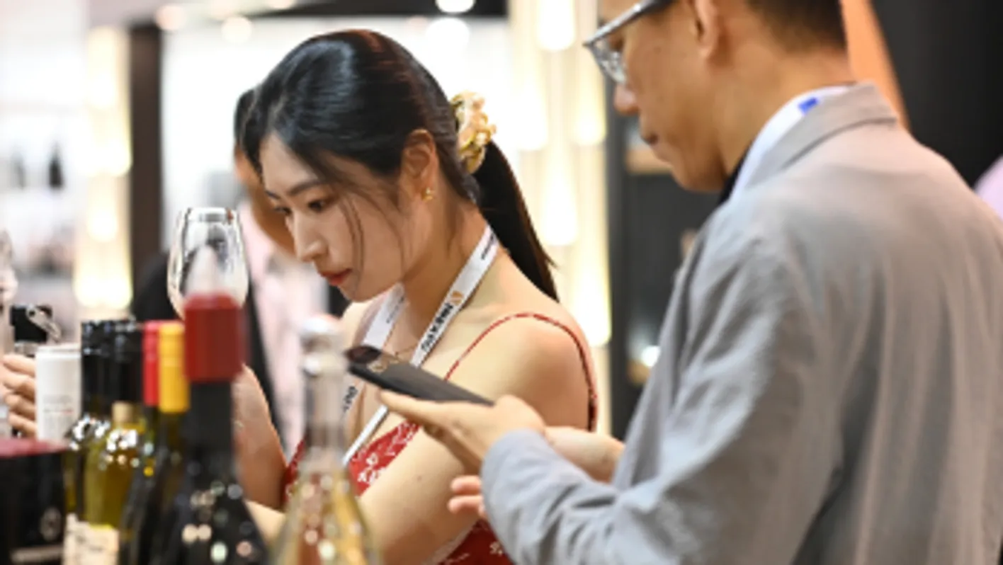 Woman tasting wine at Vinexpo Asia 