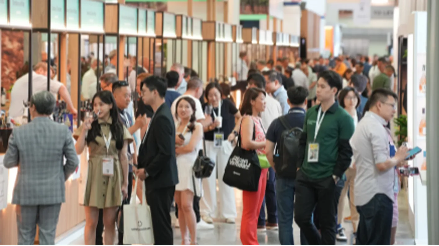 Exhibitors and visitors engaged in conversation post-event