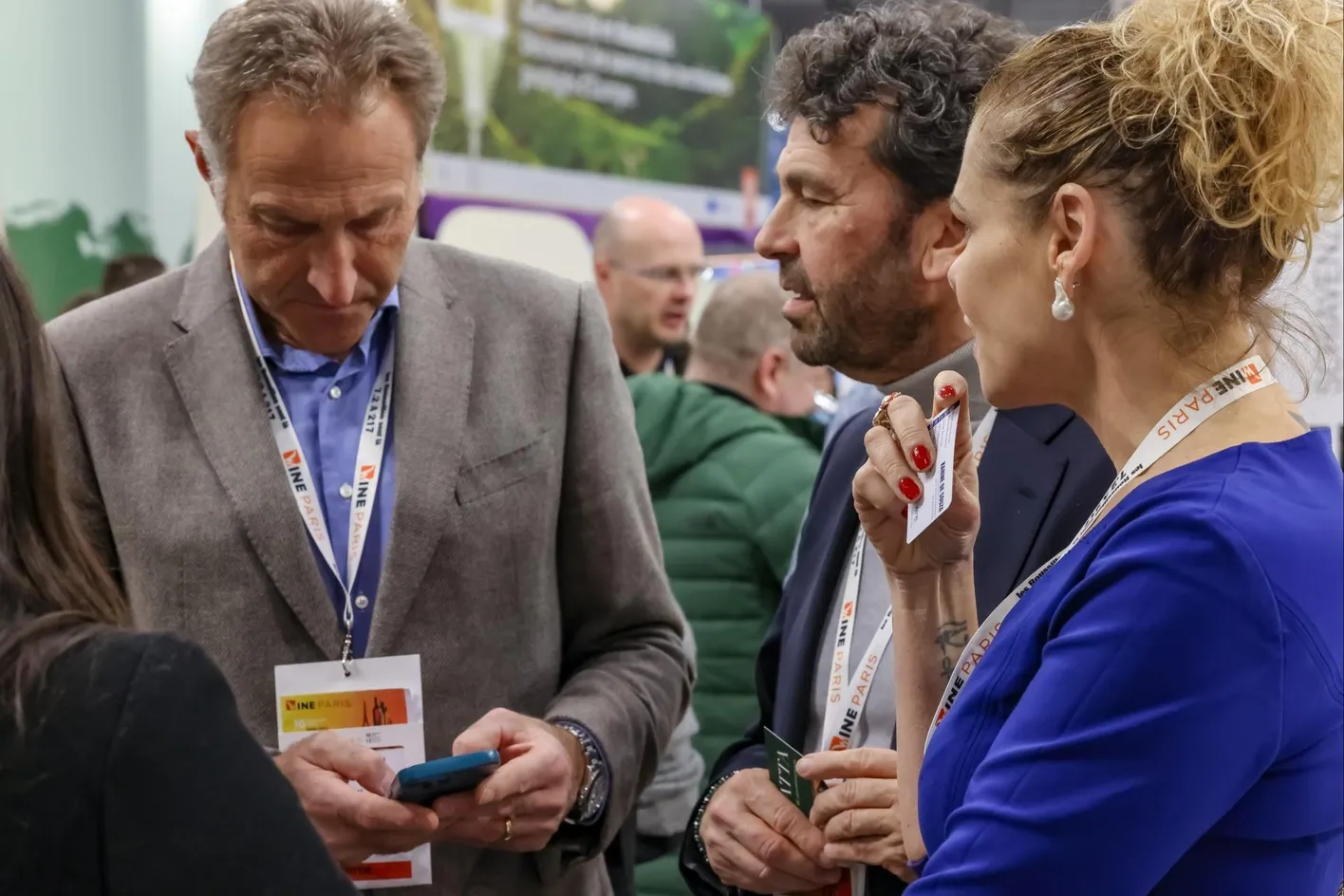 Visitors reading the detailed programme of Wine Paris event