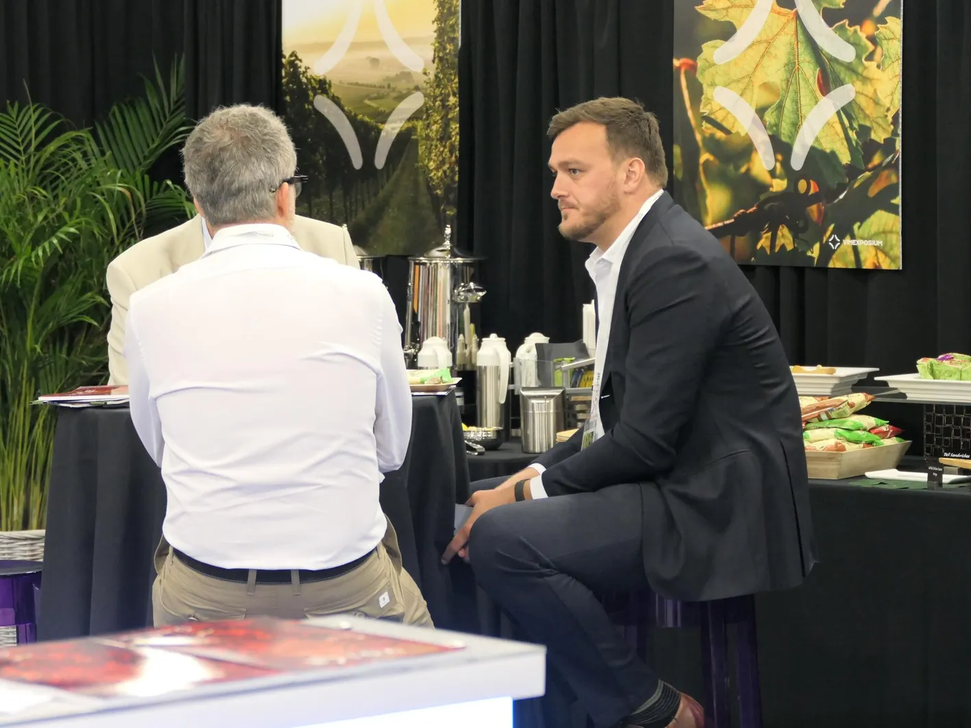 Two men are sitting and discussing.