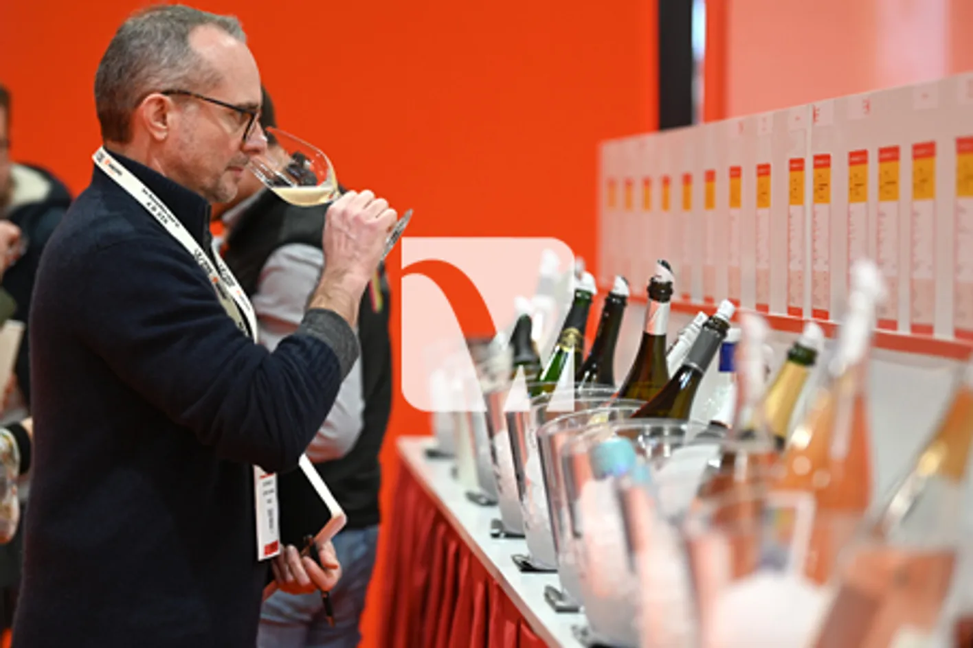 A man who is taking a sip of wine at the Free-Tasting Zone at Wine Paris.