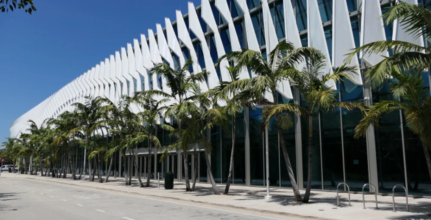 The Miami Beach Convention Center from outside, with palms.