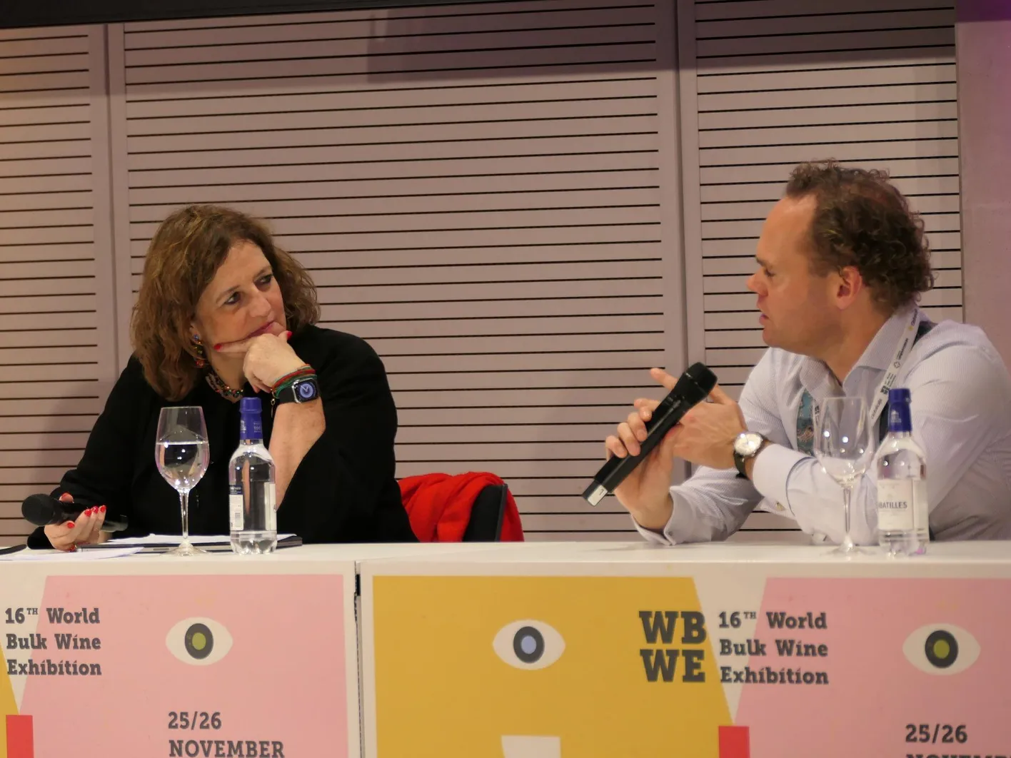 Two people who are actually speakers for a masterclass; they are talking to each other.