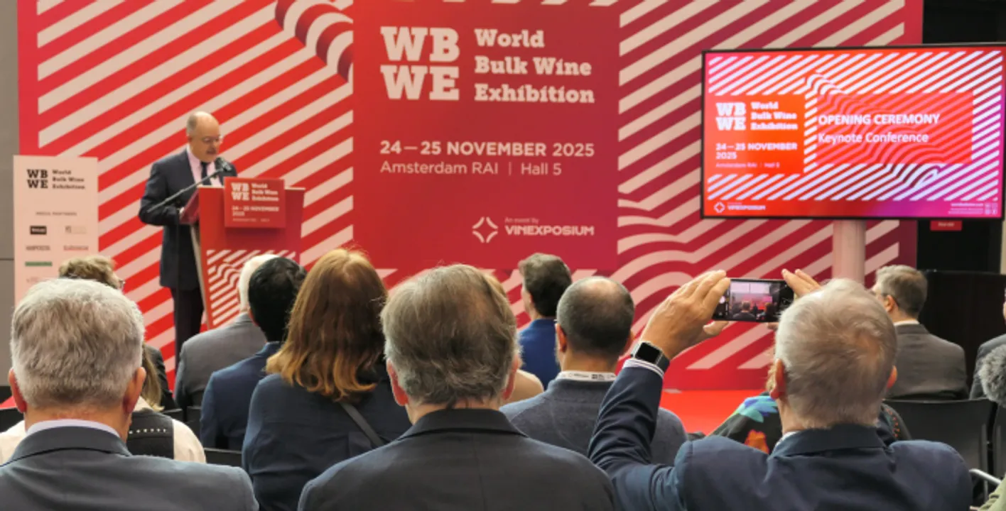 Three colored flags showing the World Bulk Wine Exhibition in Amsterdam.