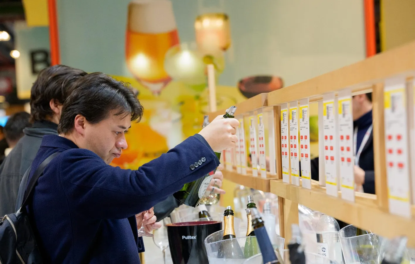 Visitors tasting wines at a stand during Wine Paris