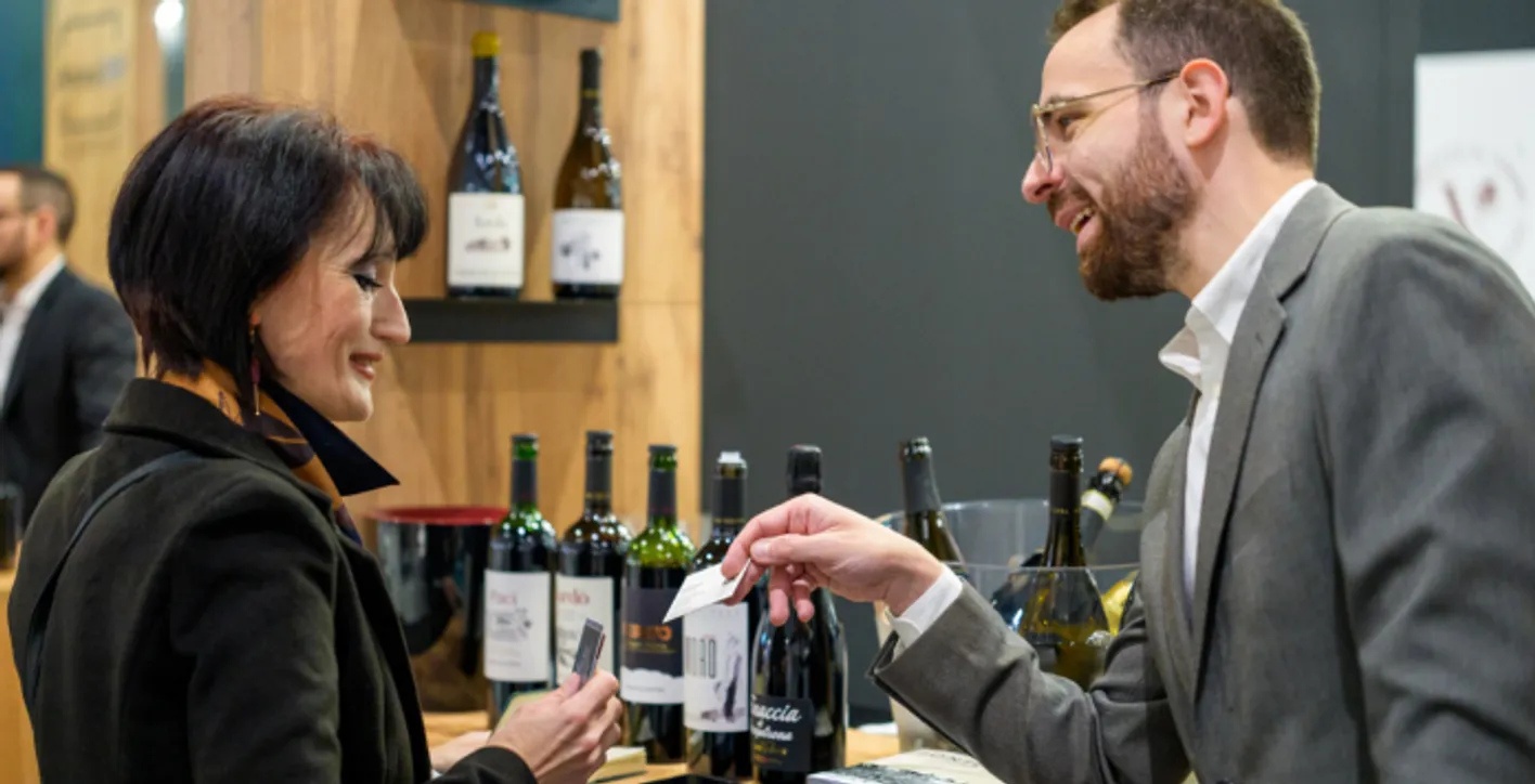 Professionals discussing at a wine and spirits showcase during Wine Paris expo