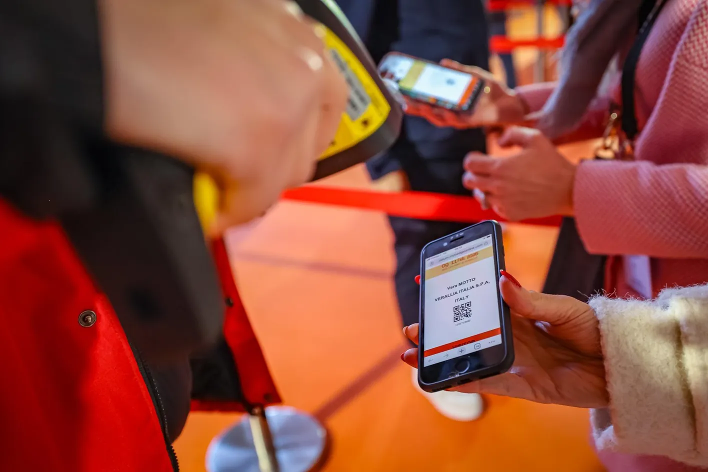 Exhibitor scanning a buyer’s badge at Wine Paris trade show.