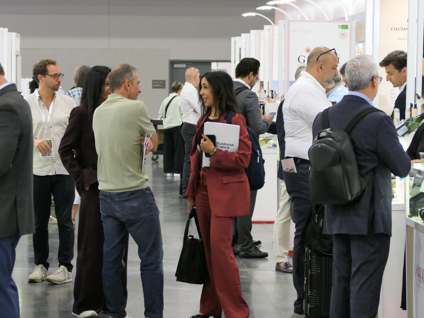 A lot of people gathered in an france pavilion aisle during the show Vinexpo Americas.