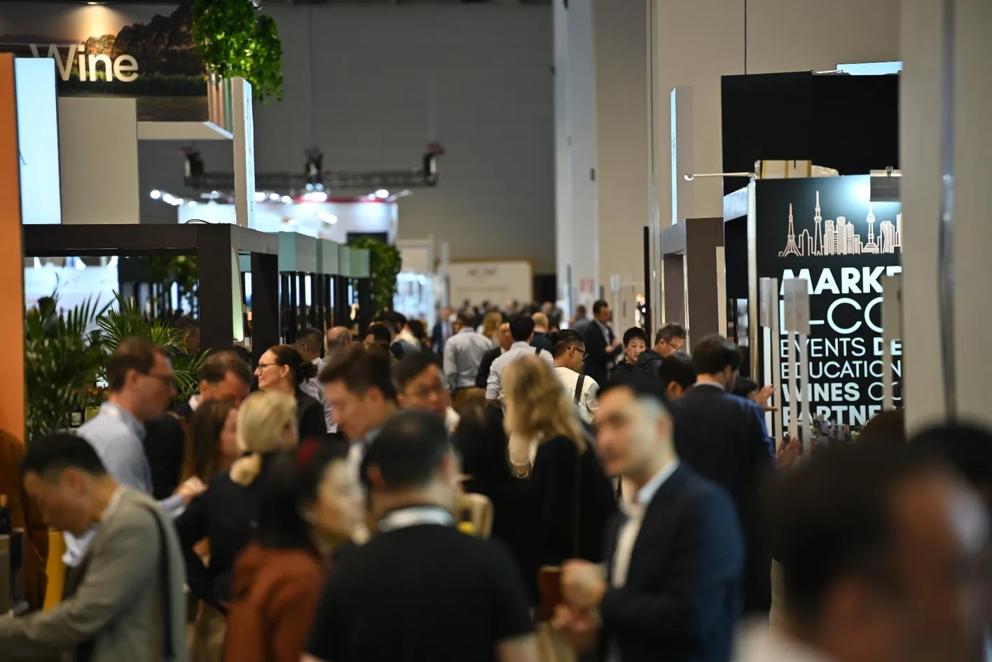 Wine buyer receiving a glass of wine from an exhibitor at Vinexpo Asia