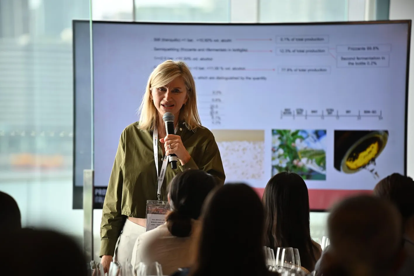 Wine professional tasting wine during a masterclass session with audio headset