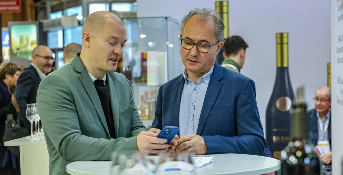 2 men checking a smartphone