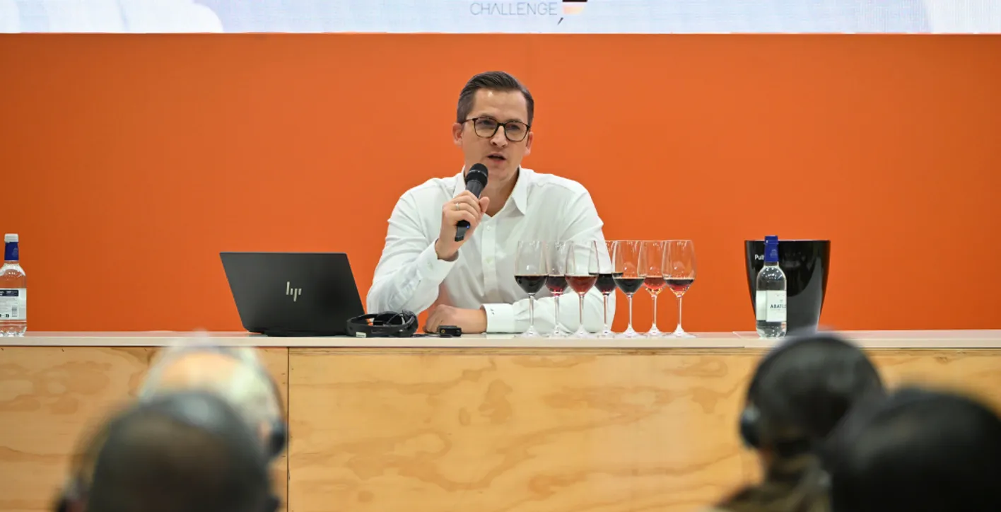 Man talking in front of public during academy session