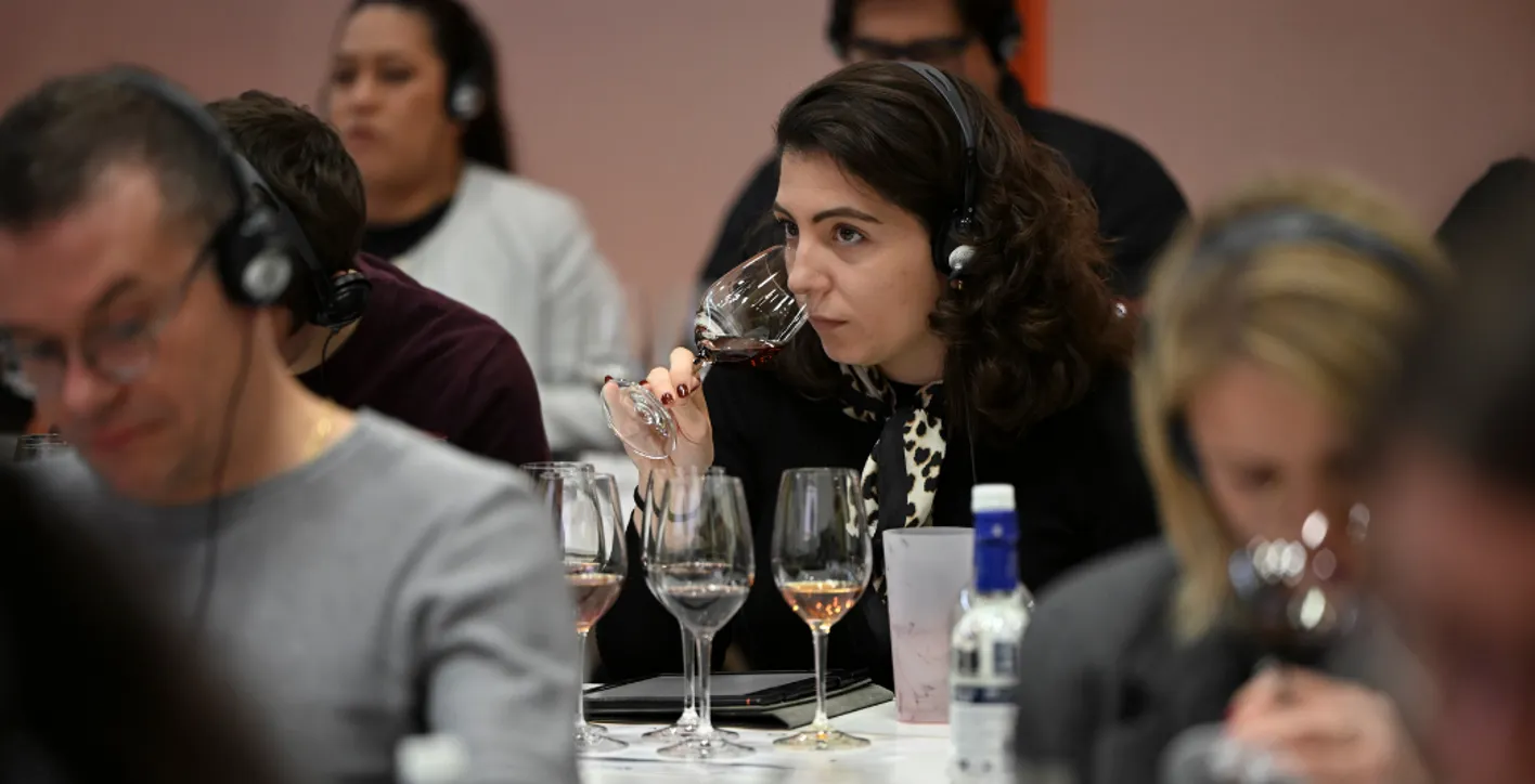 Lady tasting wine in glass during academy session
