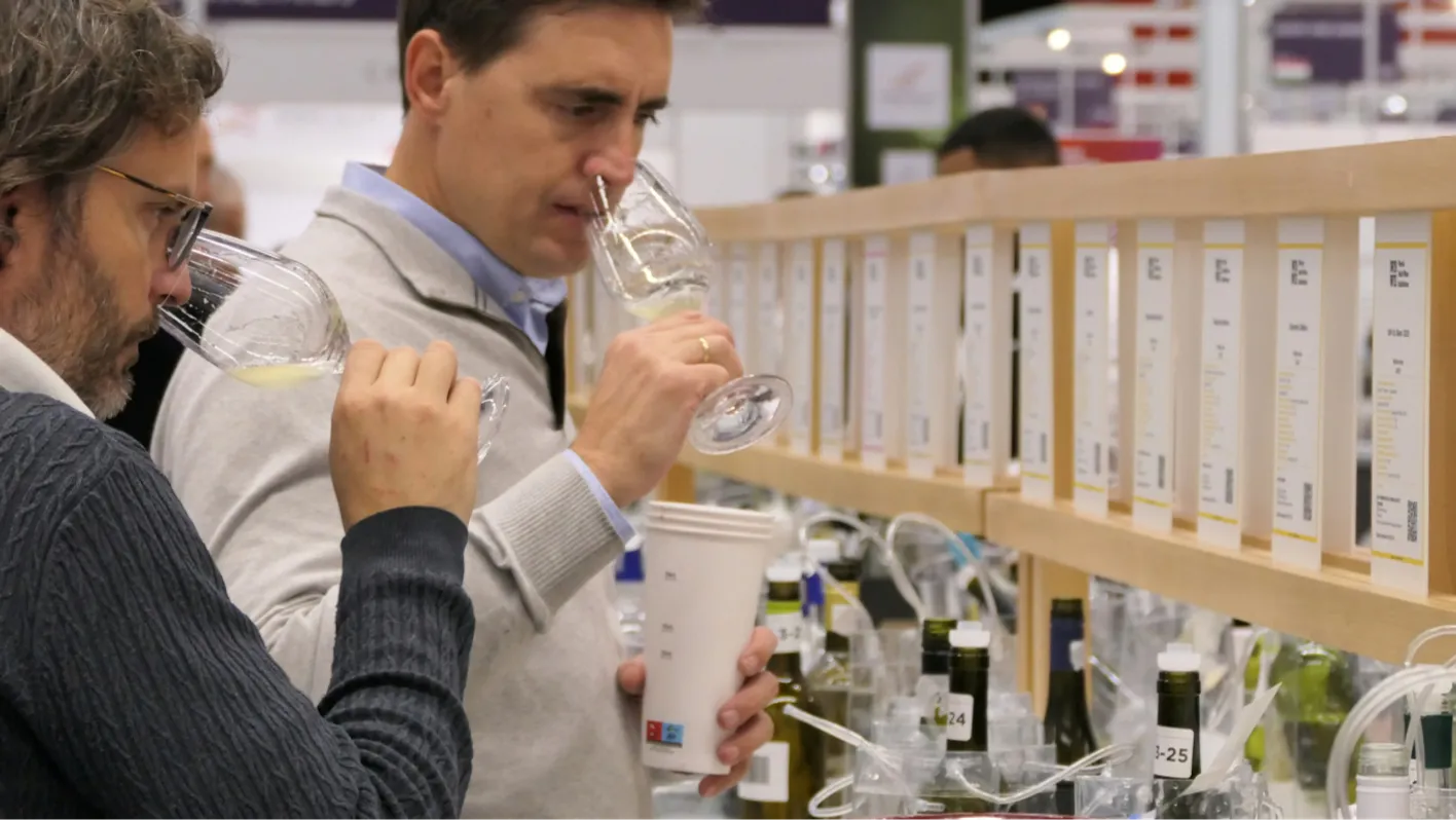 men smelling glasses of wines at the trade fair